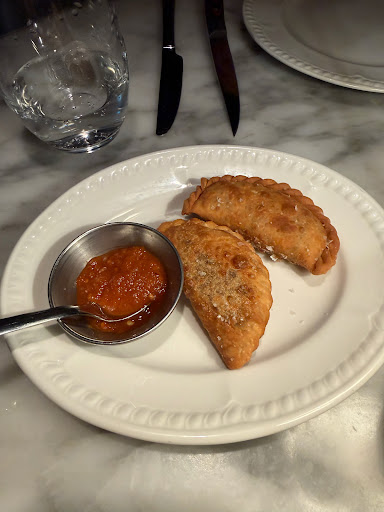 Prime rib empanadas with hot sauce